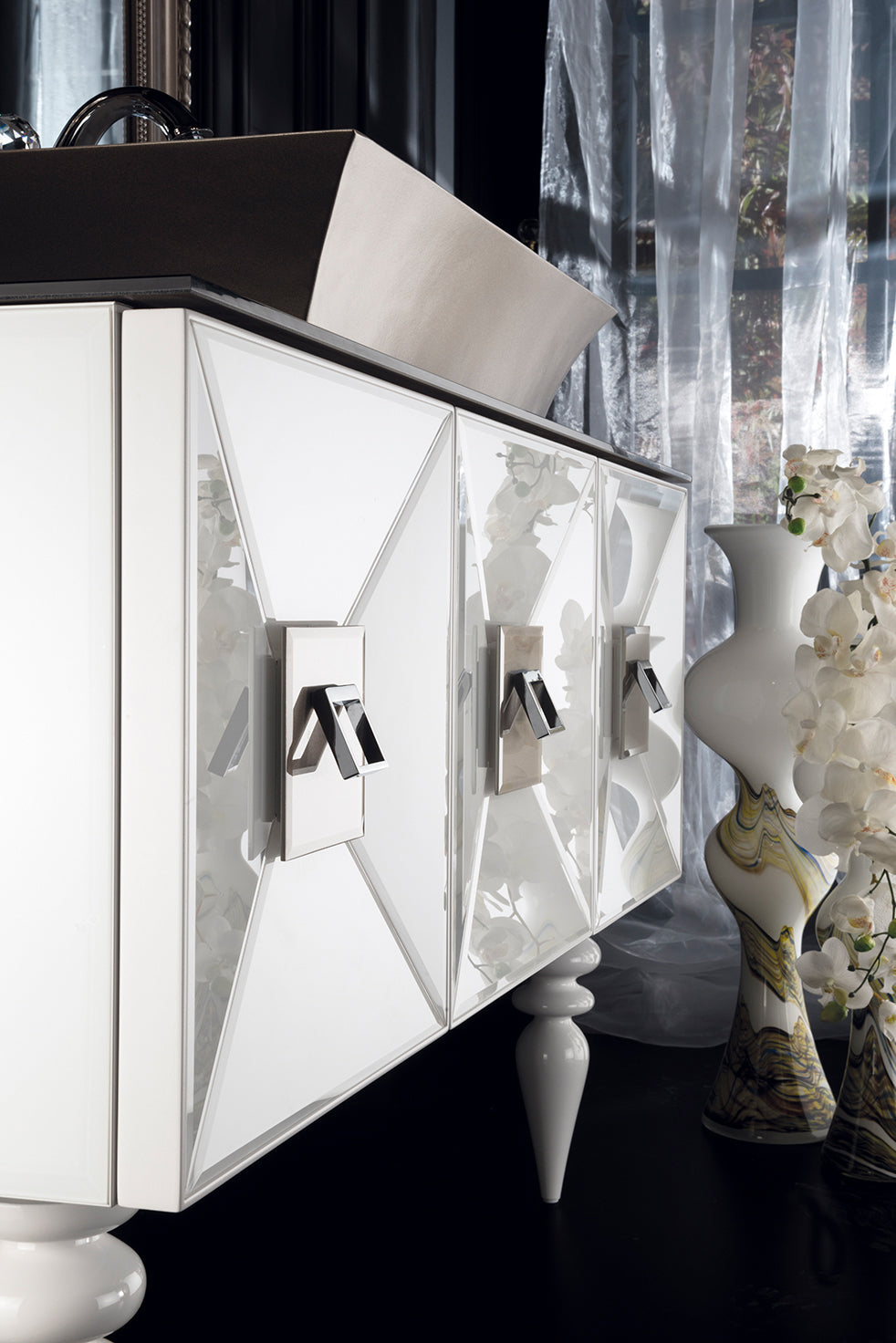 Anatolia bathroom furniture in white and gold with a golden basin and richly decorated mirror.