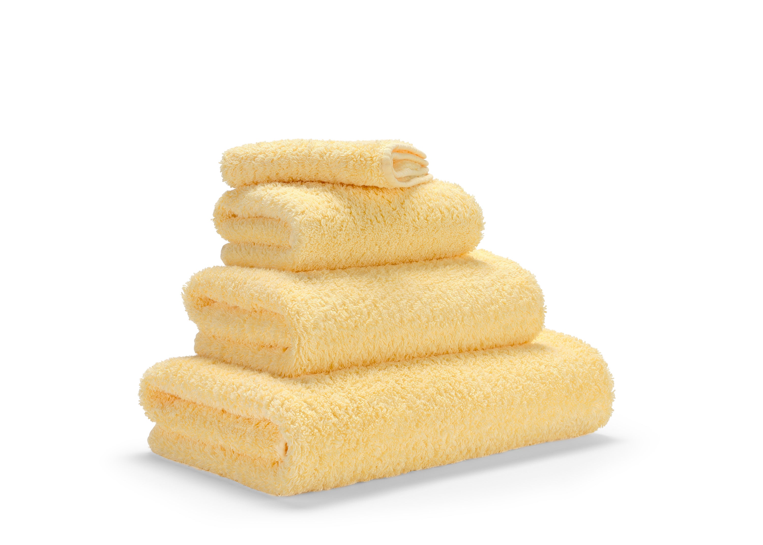 Premium towels in Egyptian Giza 70 cotton in Yellow – luxurious bathroom textile at the Tiamont shop, matching refined bathroom furniture and stylish interiors. Handmade in Portugal. 