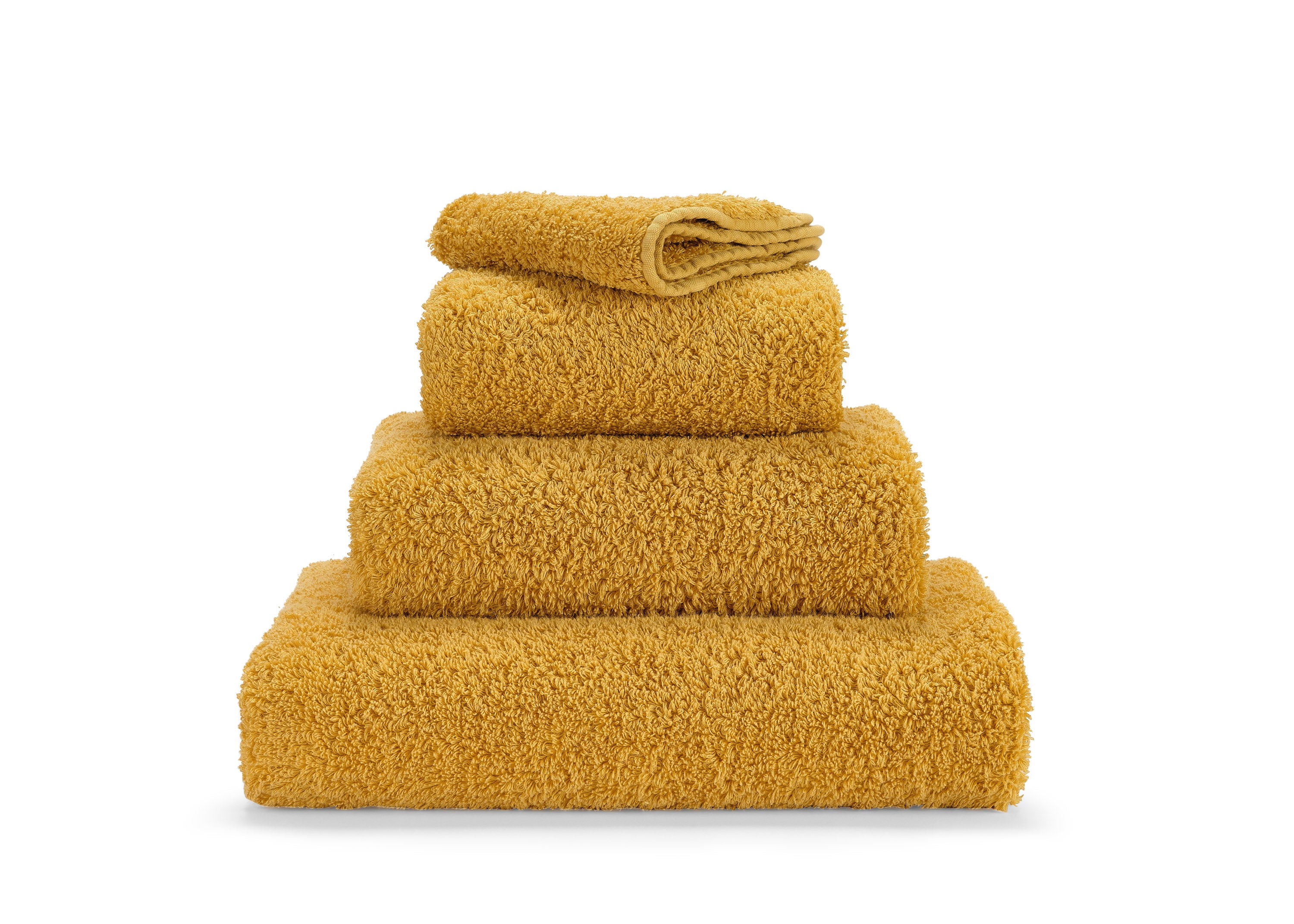 Premium towel set in finest Giza 70 cotton in gold – luxurious terry towelling from Tiamont, a perfect match for refined bathroom furniture and stylish interiors.