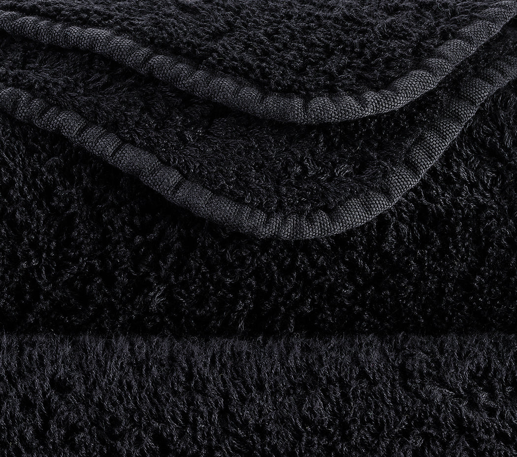 Details of the Yin premium towels in Black/Gold made from the finest Egyptian Giza 70 cotton by Abyss and Habidecor X Tiamont. Available exclusively at the Tiamont Online Boutique for refined bathroom design.